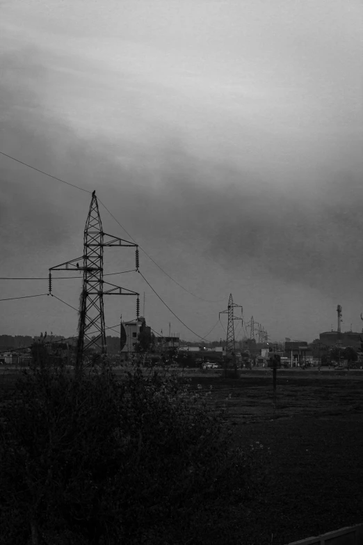 dark and gloomy landscape with telephone poles in black and white