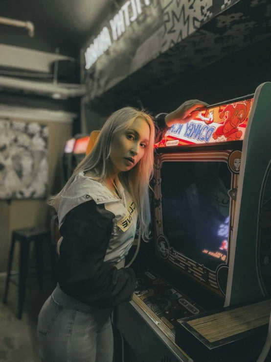 a woman in a leather jacket leaning over an old - fashioned video game