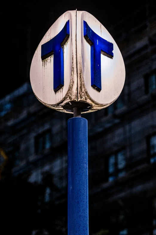 a white and blue street sign near a building