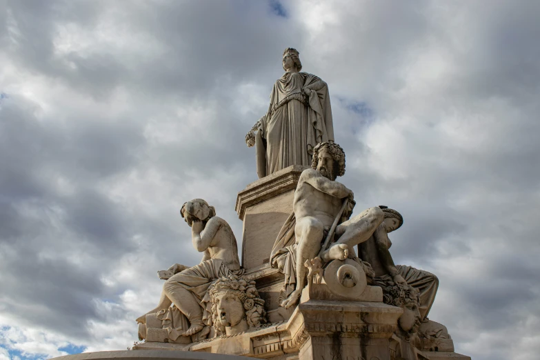 statues are standing near the base of the statue