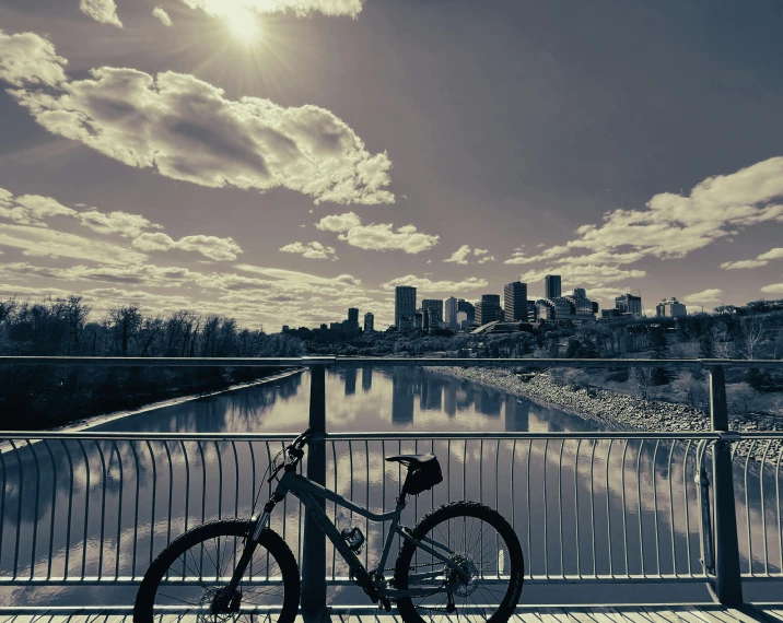 a bicycle leaning against a fence near water