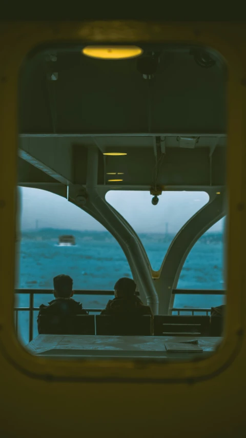 two people sitting in the back of a ferry on a boat