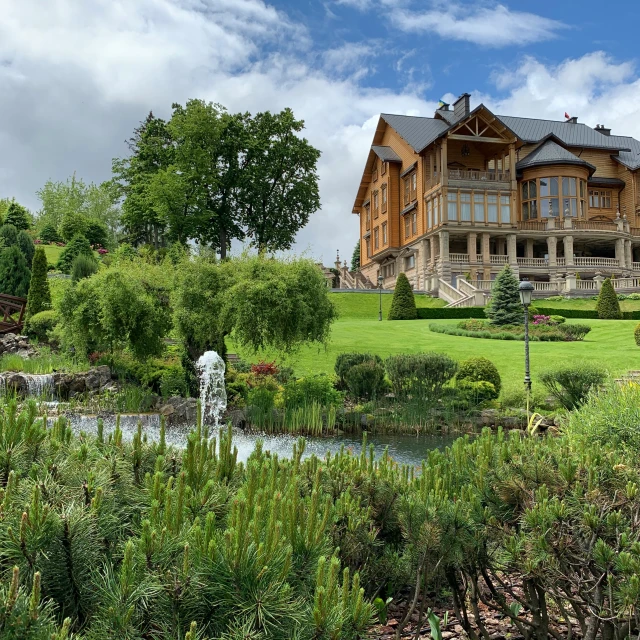 a large house in the middle of a field of bushes