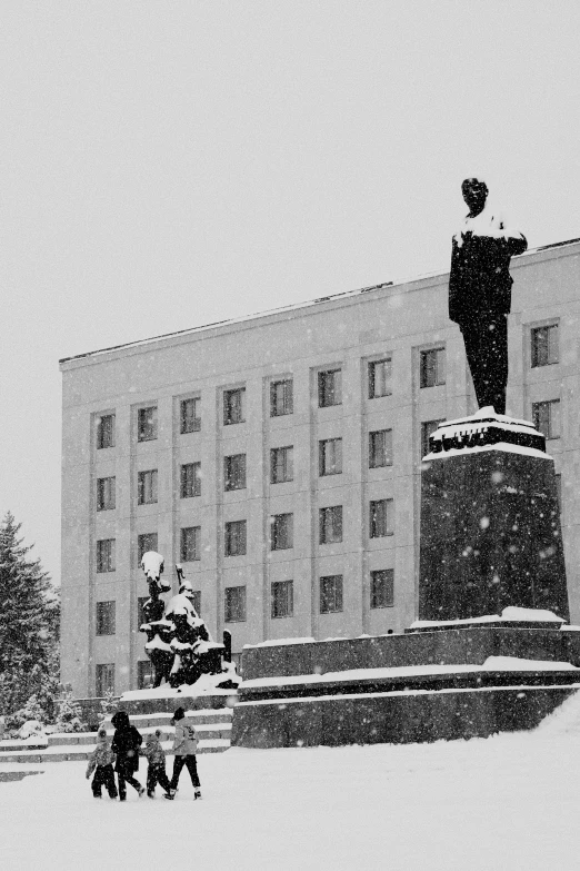 people walking near a statue on the street