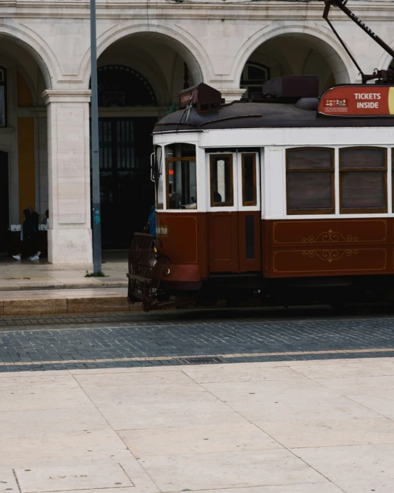 an old fashioned cable car on the street in the city