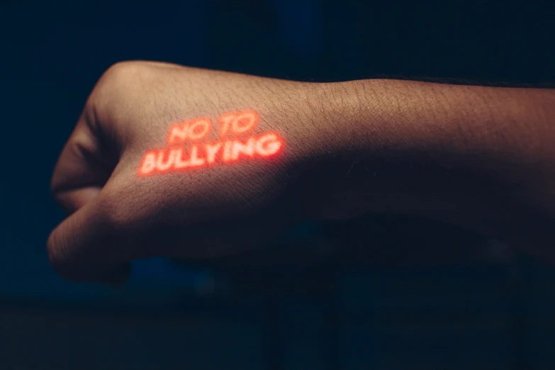 a close up of a wrist with neon signs on it