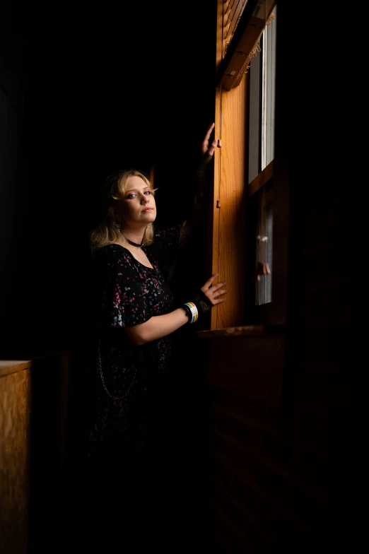 a woman looking out of an open window