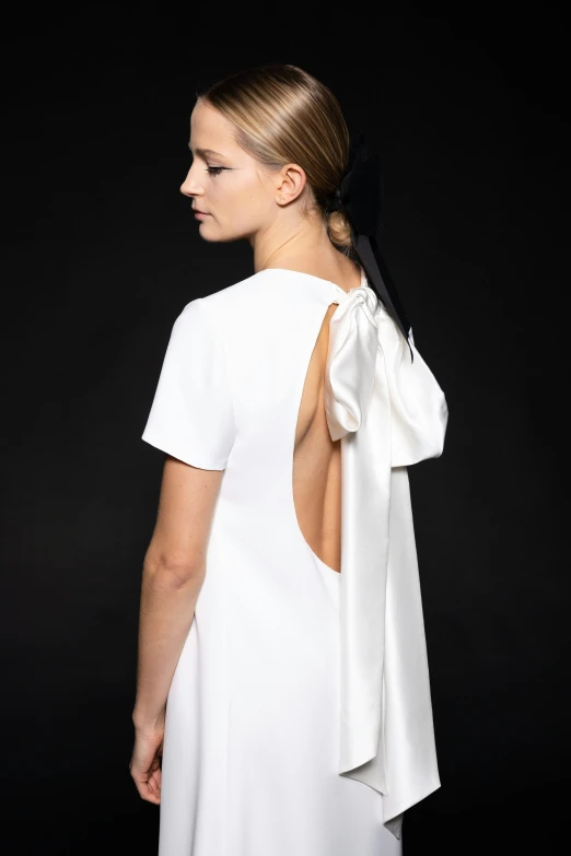 the back of a woman with a dress and hair