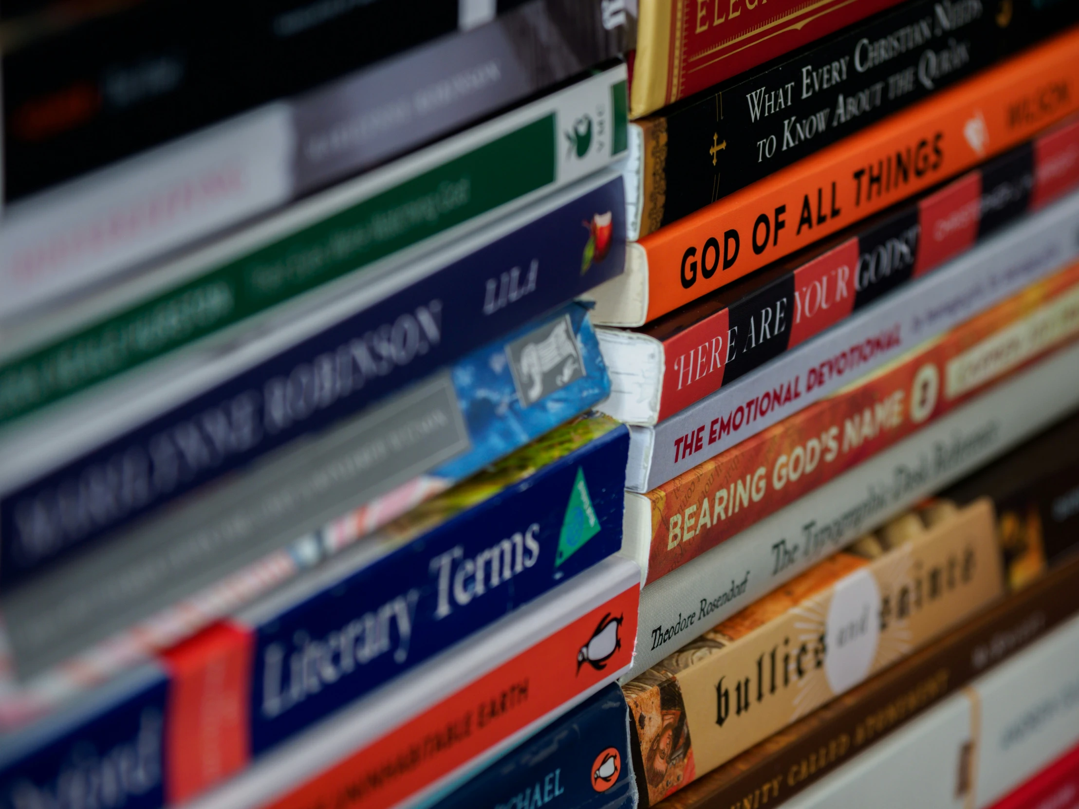 a large stack of bibles are piled on top of each other