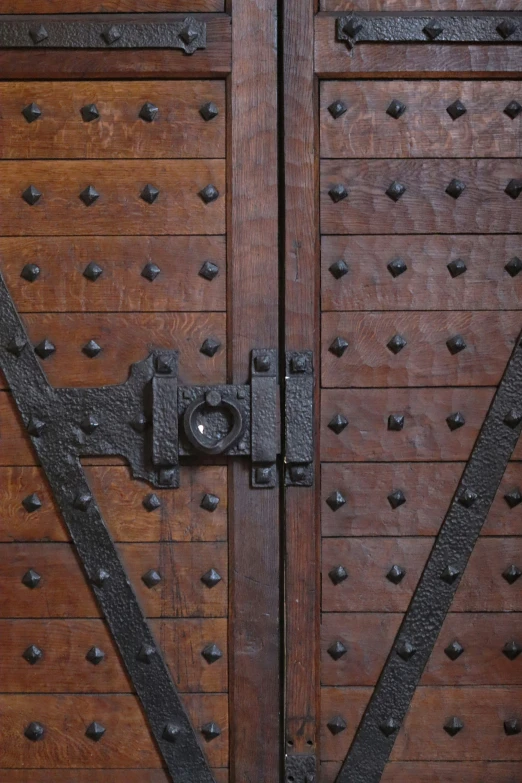 a brown door with metal studs on it