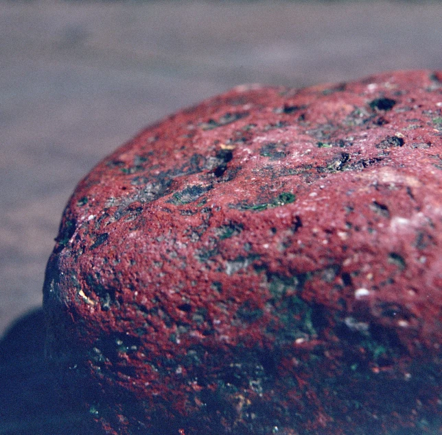 a very old looking rock sitting on the ground