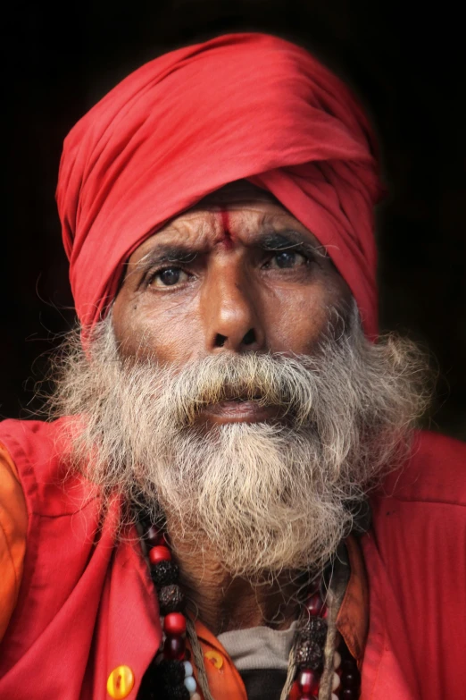 a man in red outfit with a long beard