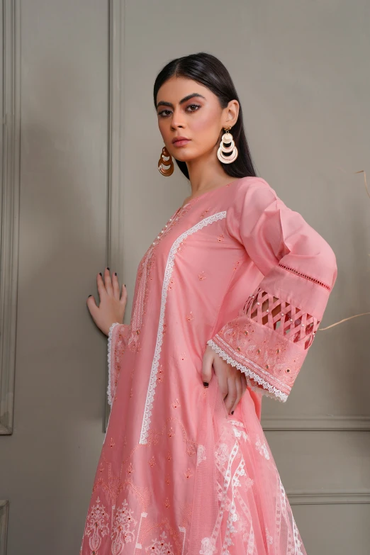 a woman in pink dress standing up