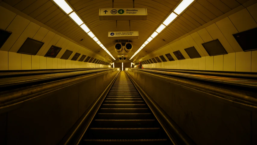 an empty subway area with escalator rails and a walkway