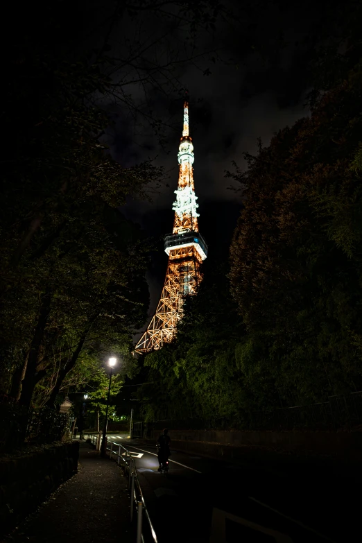 a cityscape is shown at night, including the eiffel tower lit up in gold and white