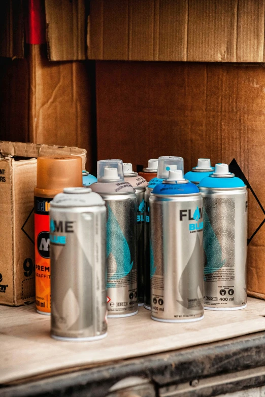 an array of soda cans sit on top of the shelf