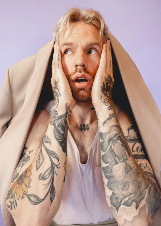 man with tattoos covering his face and nose