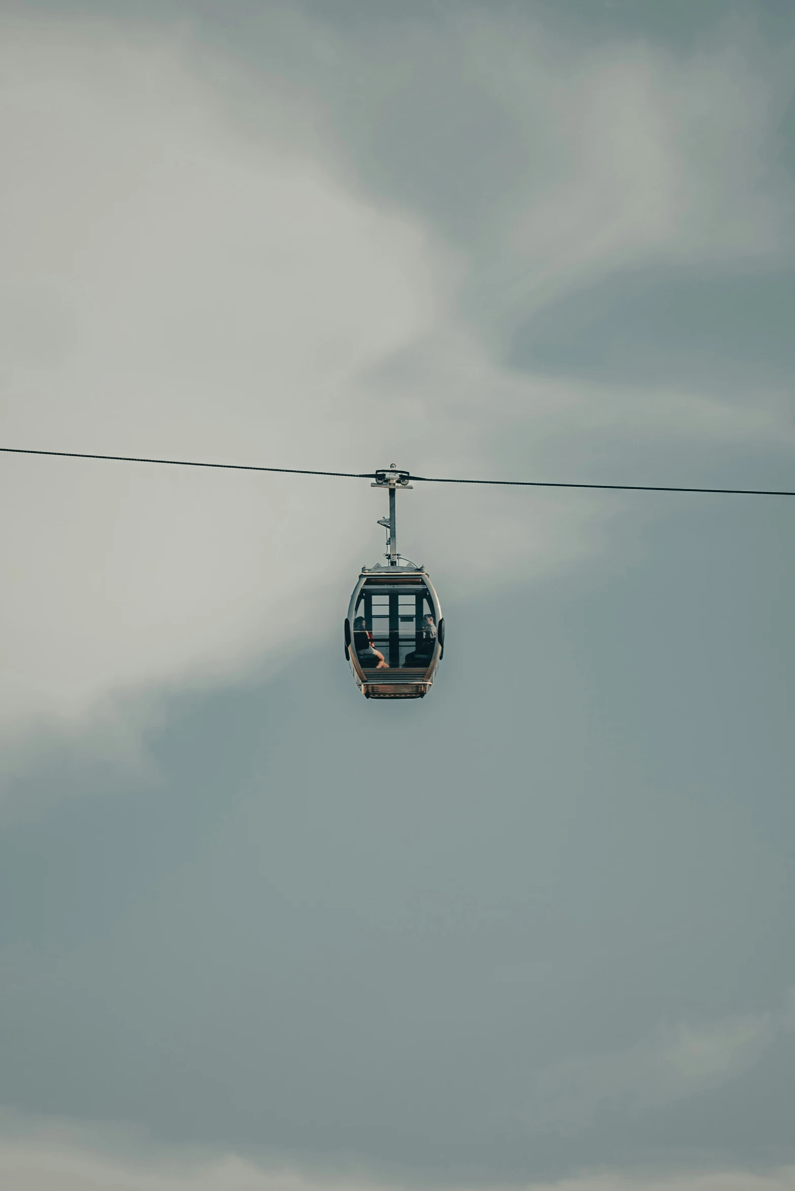 a gondola with people inside in the sky