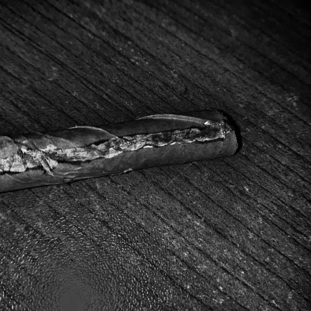 a broken cigar on a wooden table top