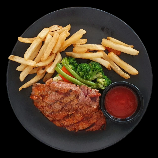 a plate of food with fries and steak with vegetables