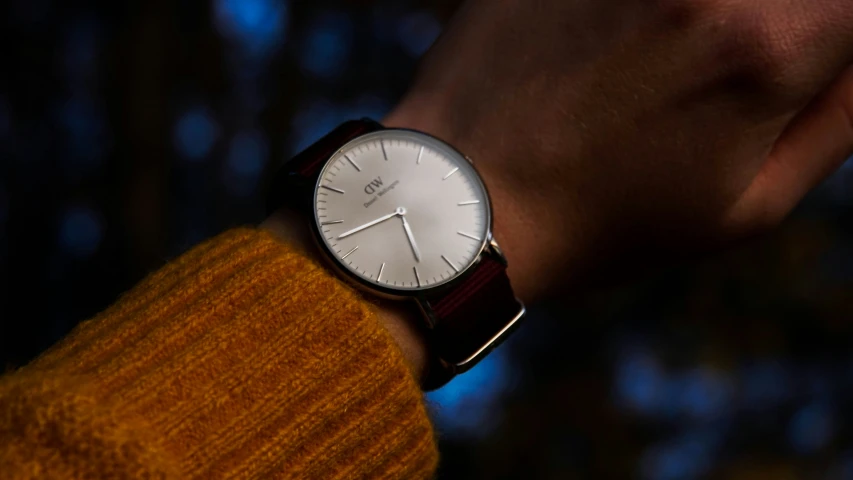 a person wearing a watch and standing in the dark