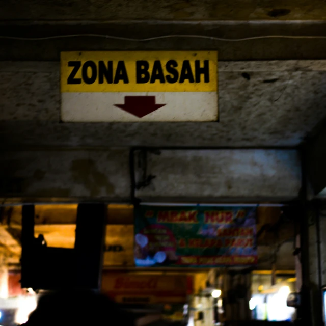 an orange sign that says zona bash under the road