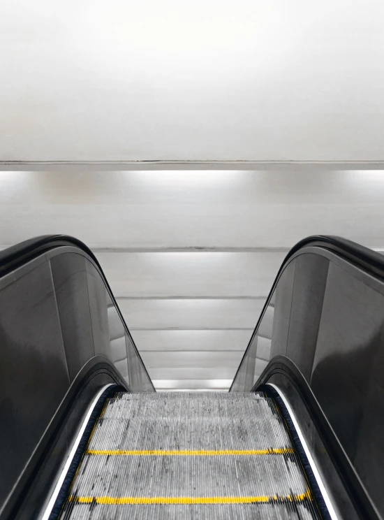 a person riding an escalator down a flight of stairs