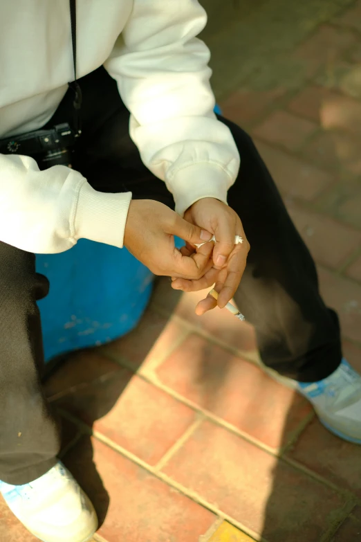 person sitting on the ground holding soing in their hand