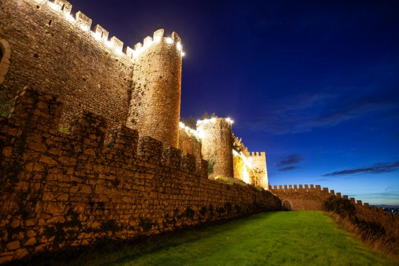 the castle is illuminated by many lights in the dark