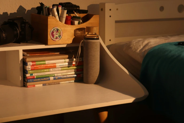 a shelf in the corner of a room that has books on it