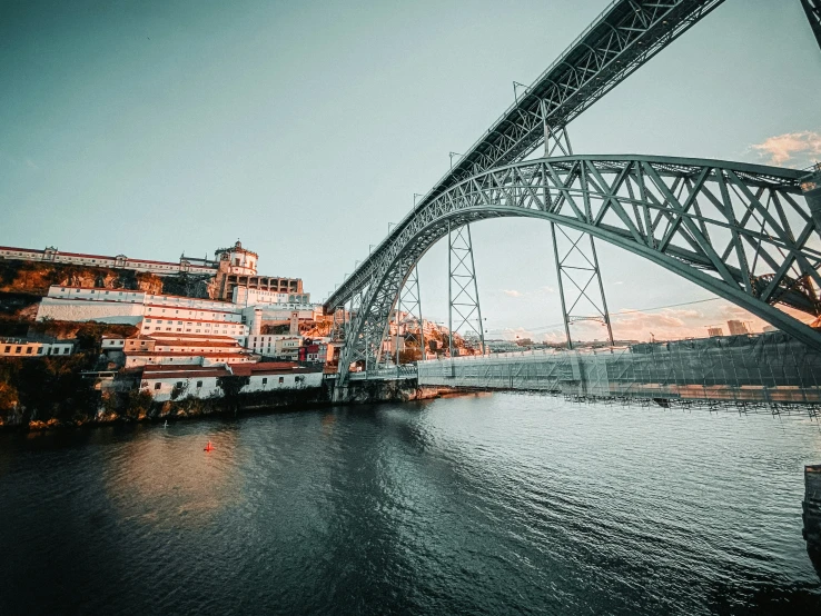 an old po of a bridge with a river running below it