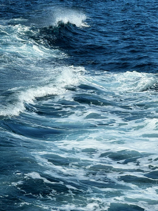 a small surfer rides the waves in the ocean