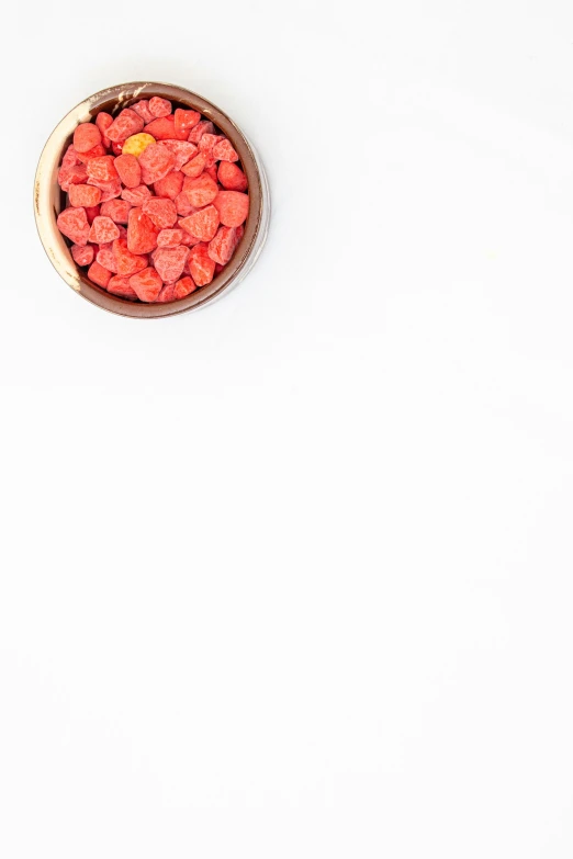 a bowl of raspberries on white background