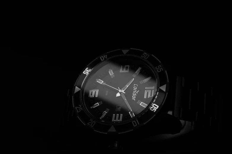 a watch is seen on the black background