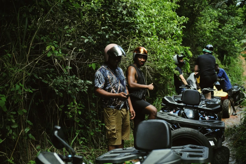 people on motorcycles stopped on a narrow dirt road