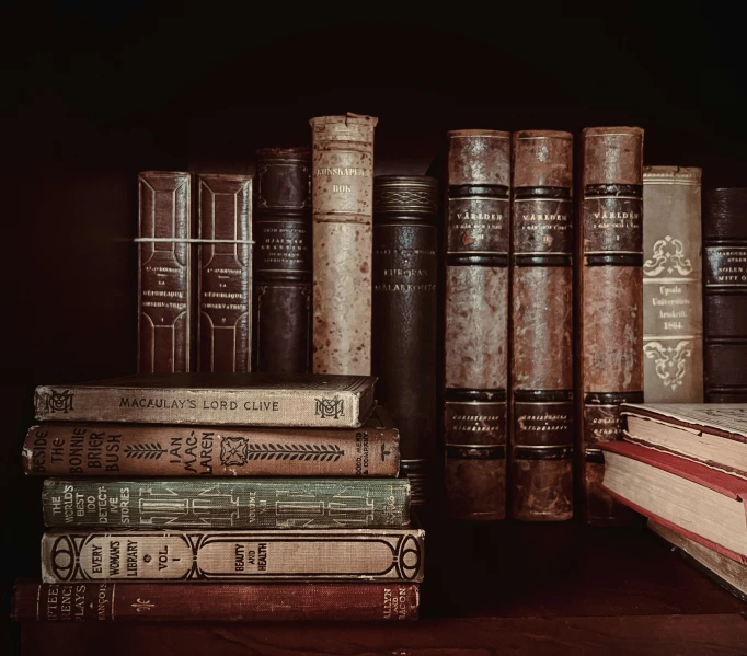 a table topped with lots of different books