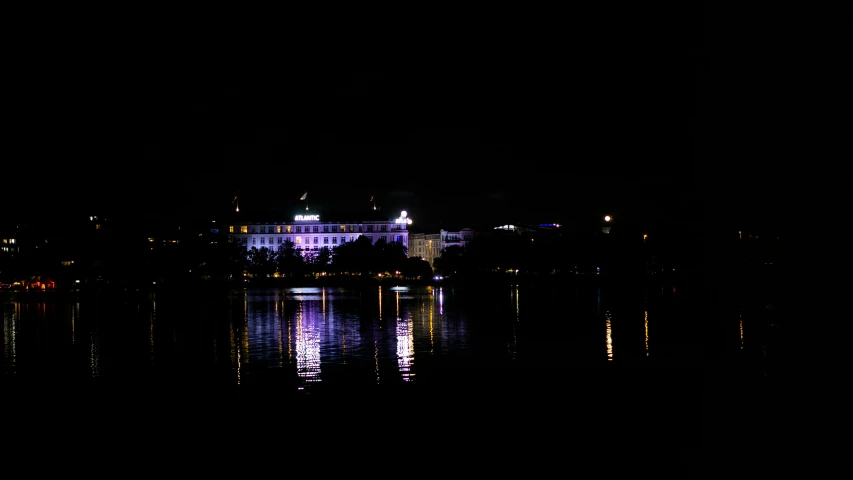 the palace and surrounding buildings in the background is seen in the night