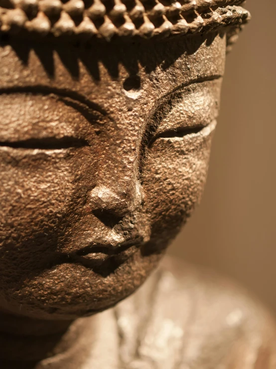 a buddha statue made with very dark stone