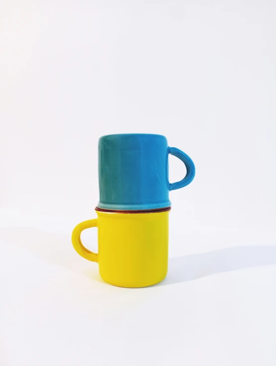 two colorful cups stacked on top of each other