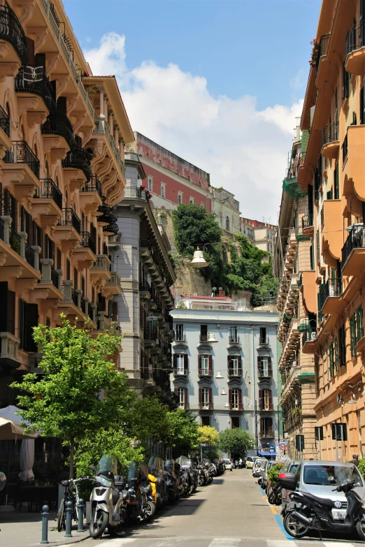 a street with several cars and motor bikes