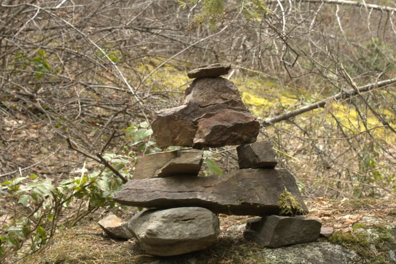 a stone balanced balancing on a rocky outcropping