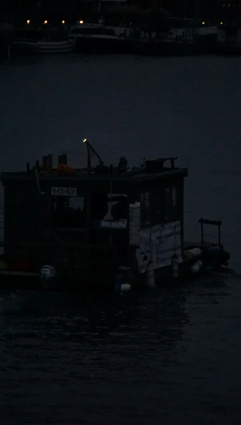 a floating house boat traveling down a river at night