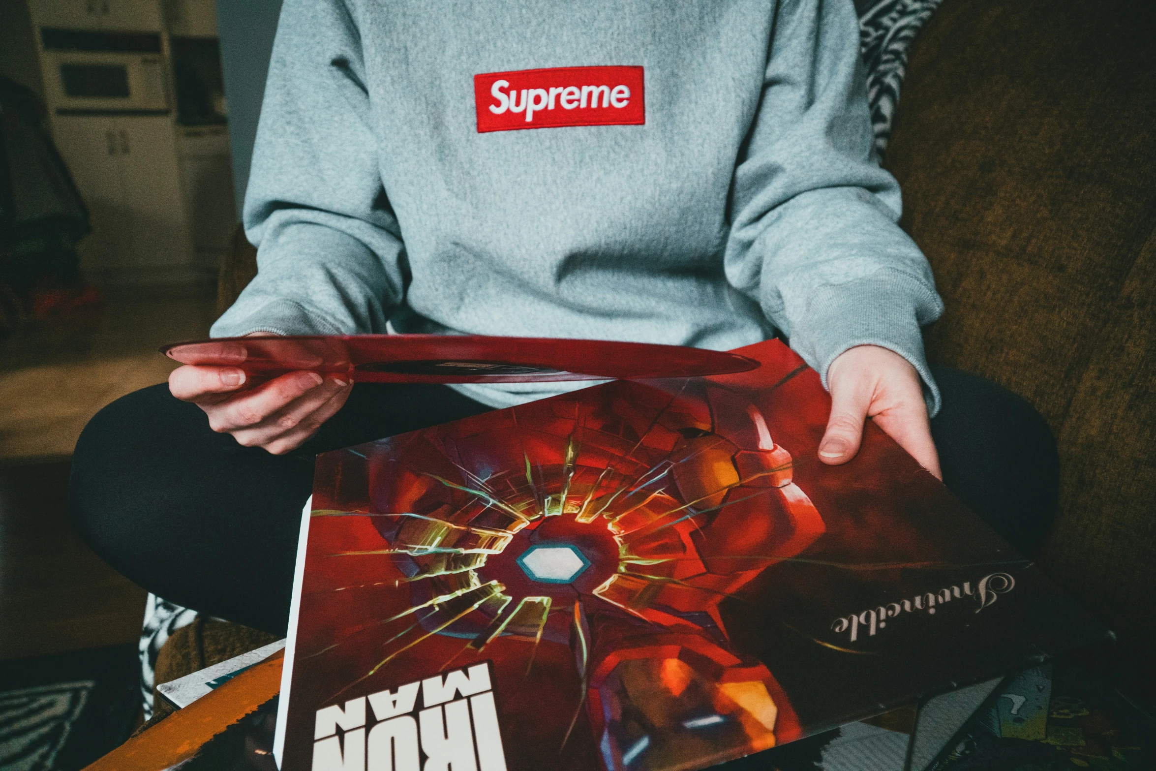 someone holding a box with a poster on it