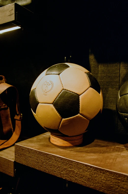 there are three sports items sitting on a shelf