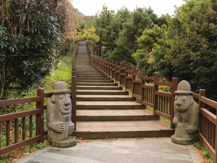 two wooden steps leading up to various statue heads