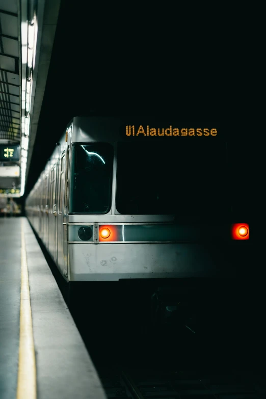 a metro train with its lights on in the dark