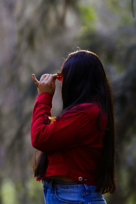 a person taking a picture with a camera in a park