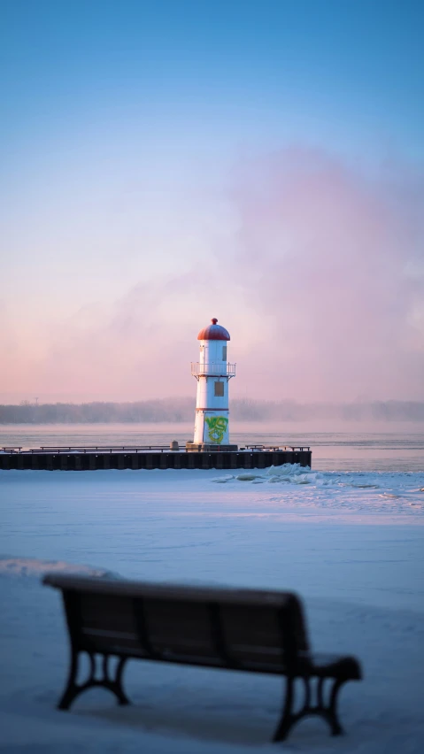 the sea and pier with a bench near by