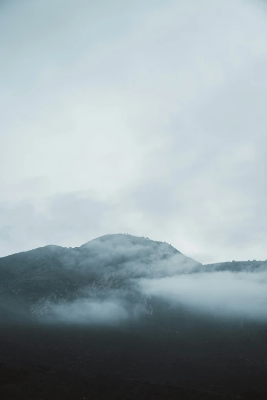 a picture of a mountain in the clouds