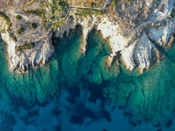 an aerial s of blue water with green trees in the background